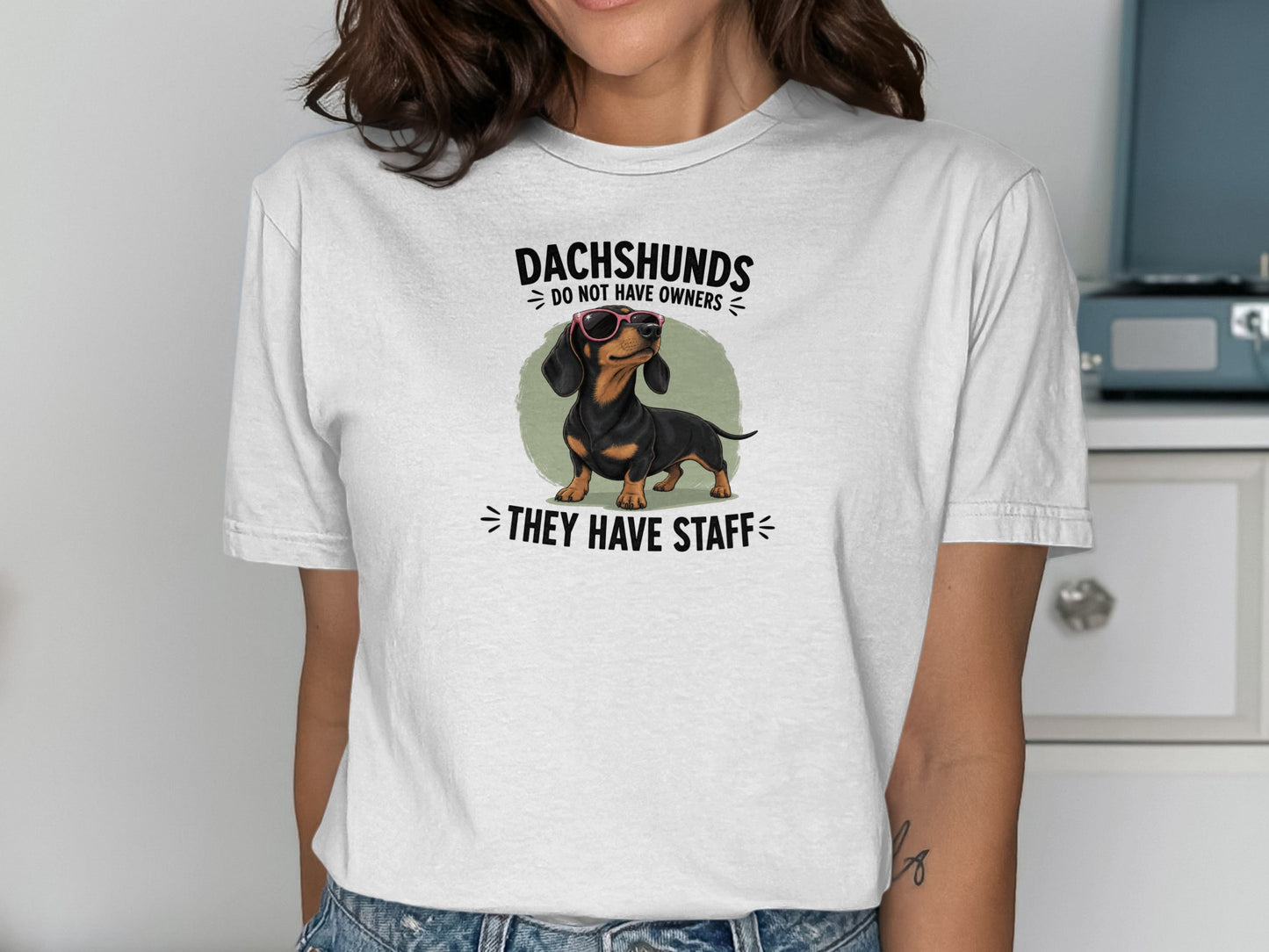 White t-shirt with dachshund graphic and "Dachshunds do not have owners, they have staff" text.