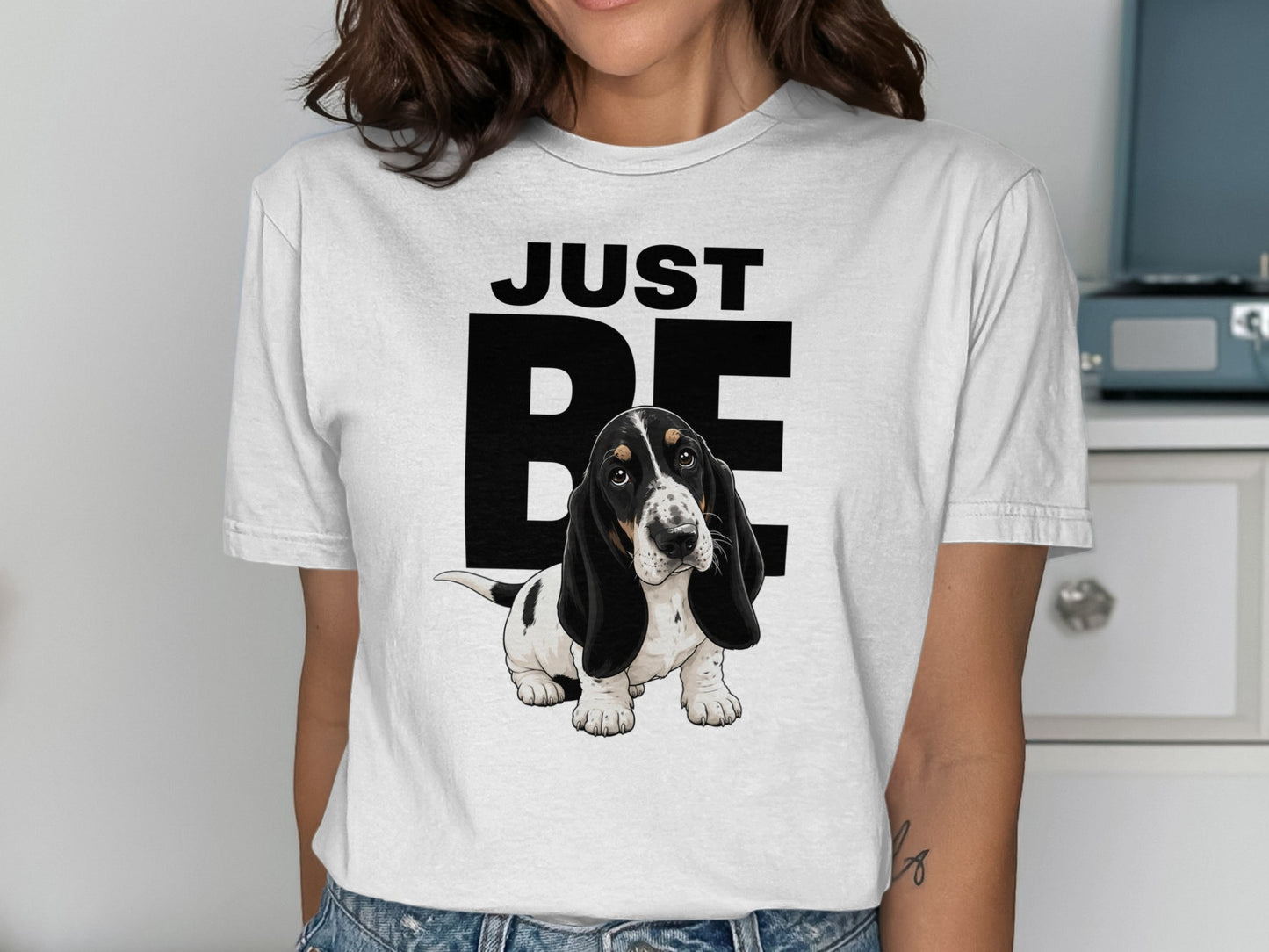 White t-shirt with "JUST BE" text and a cute basset hound puppy.