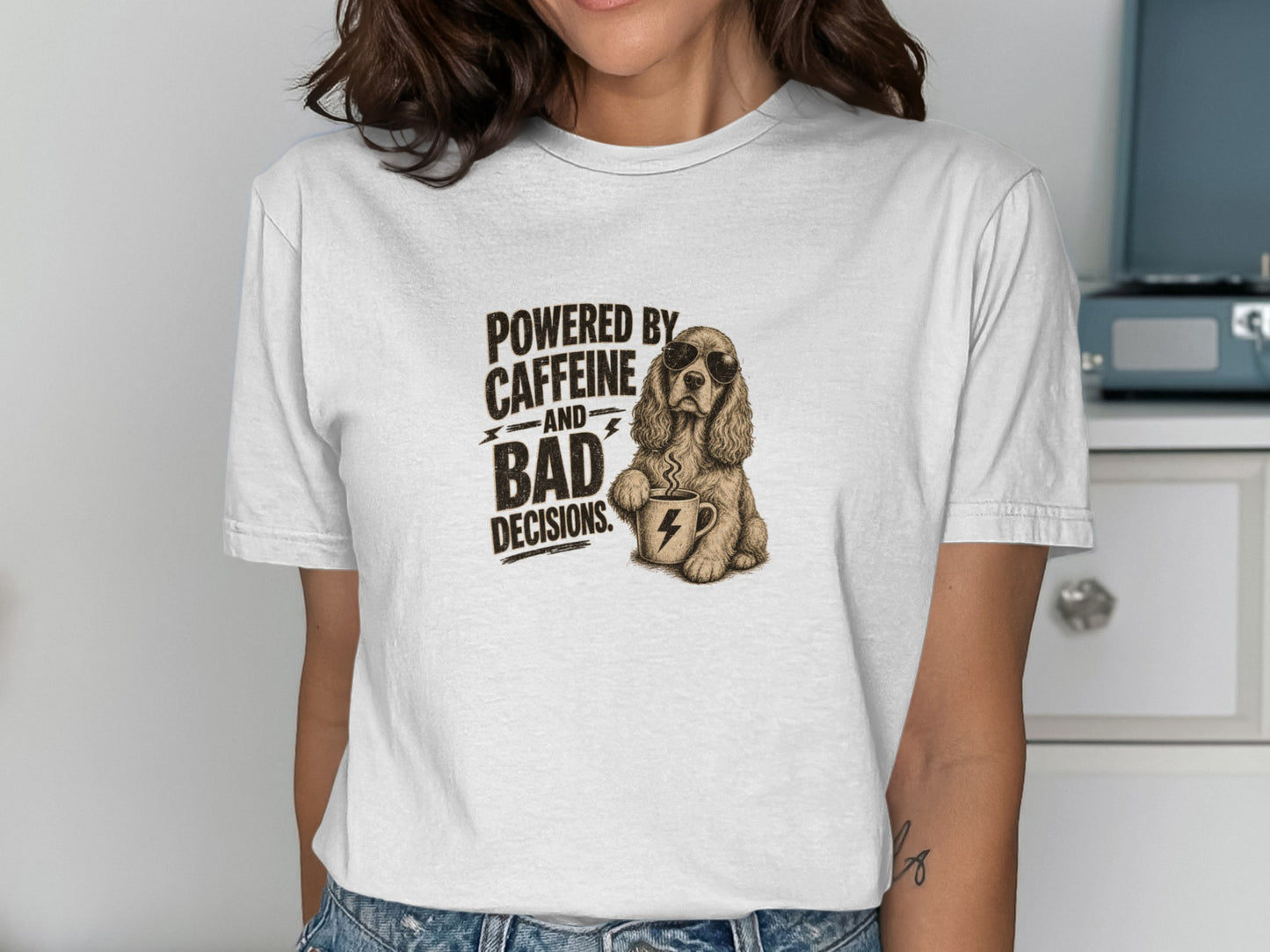 T-shirt with dog wearing sunglasses holding coffee cup, text "Powered by Caffeine and Bad Decisions."