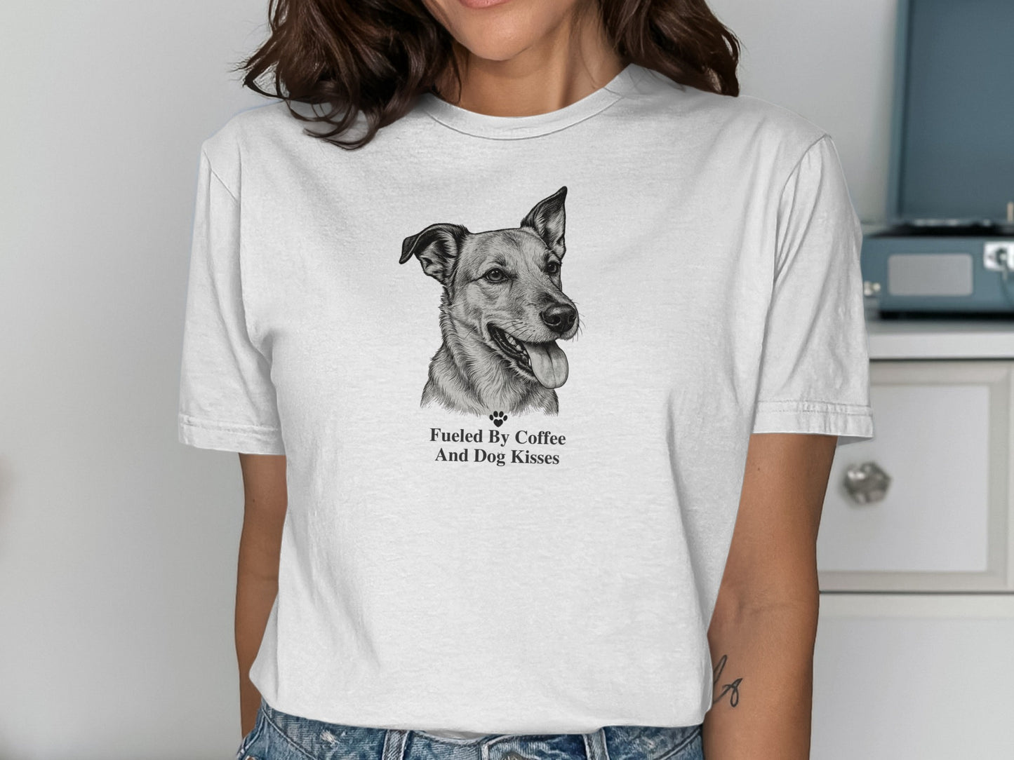 White t-shirt with a sketch of a dog and text "Fueled By Coffee And Dog Kisses."