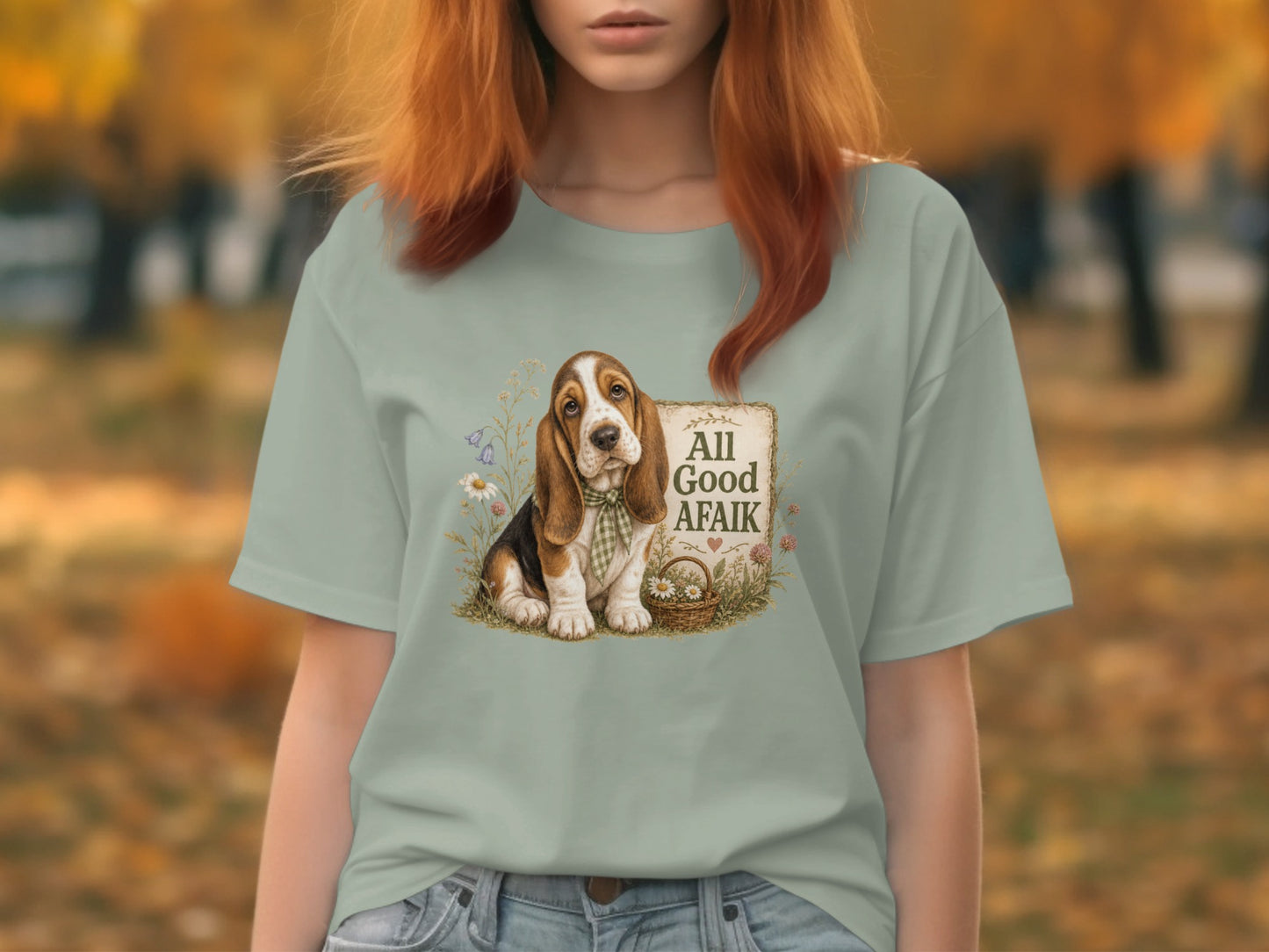 Basset hound wearing a checkered bandana sits by a sign that reads "All Good Afaik".