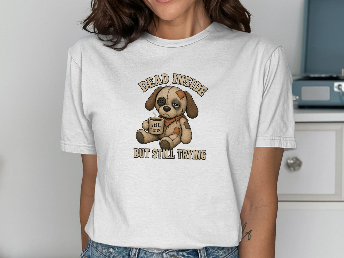 Illustration of a sad dog wearing a bandage, with text "DEAD INSIDE STILL TIRED".