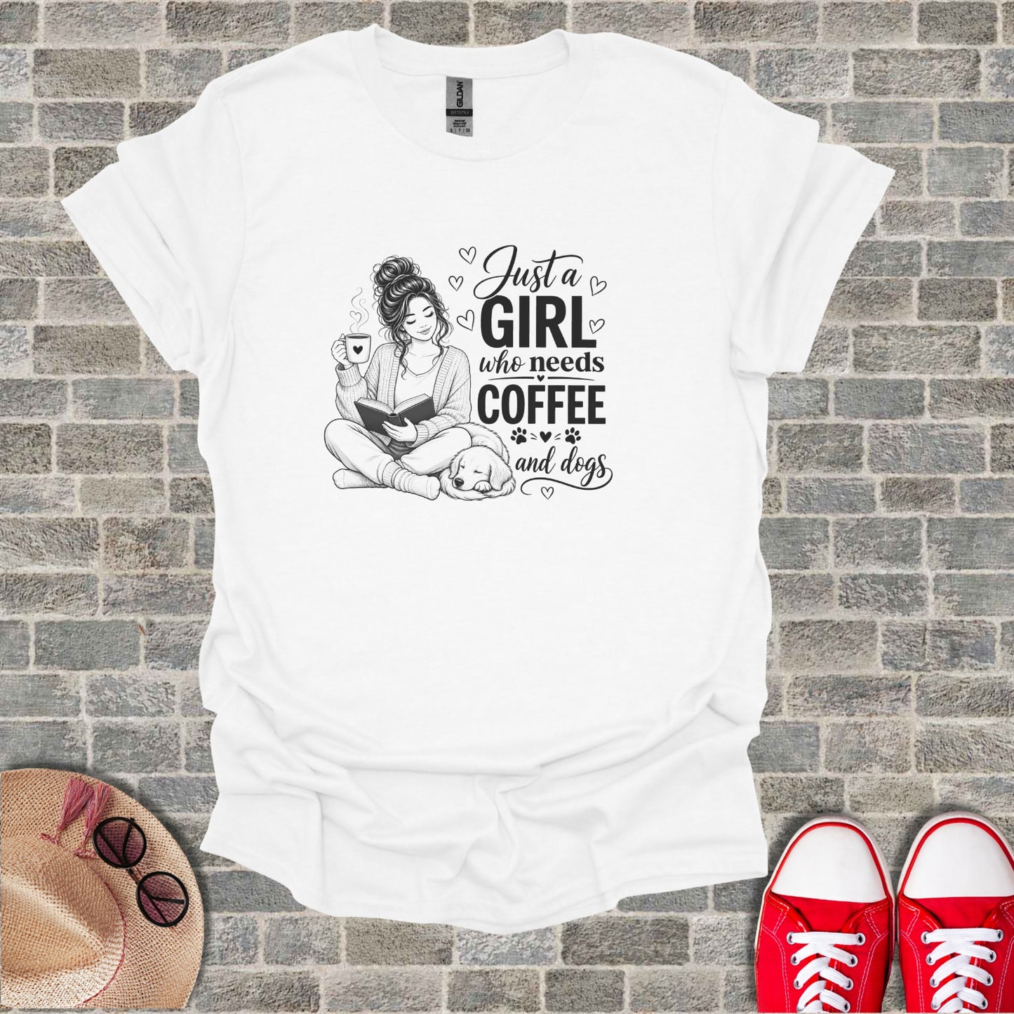 White t-shirt with "Just a girl who needs coffee and dogs" text and illustration.