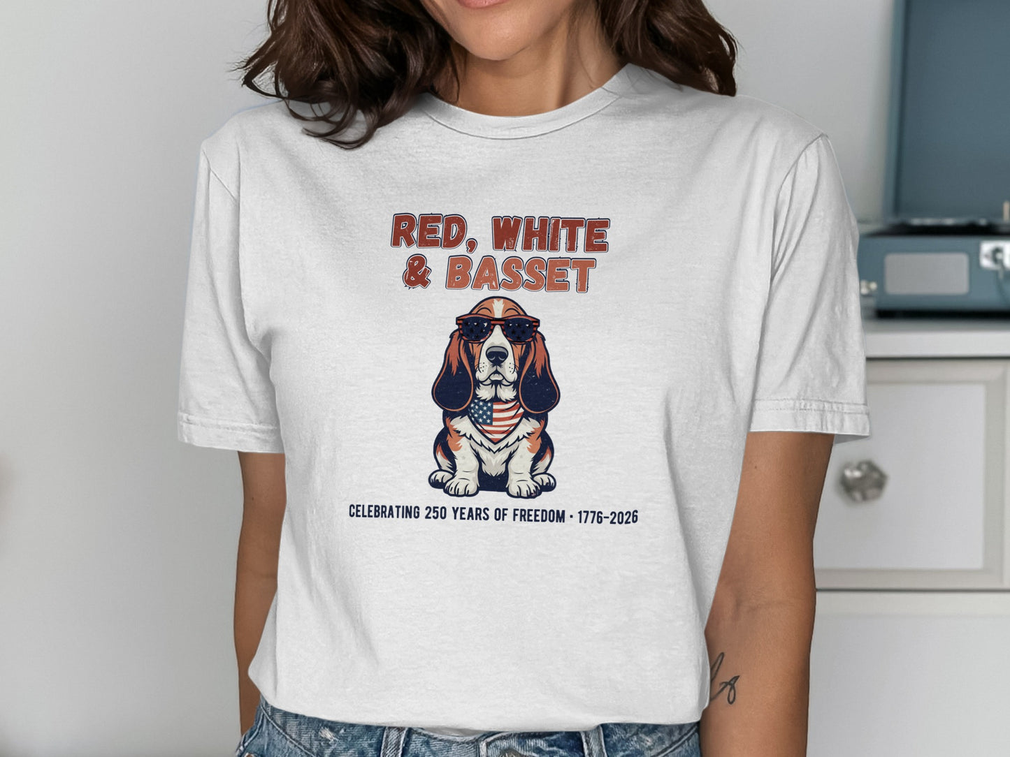 Basset hound wearing sunglasses and a flag bandana, text reads "Red, White & Basset".