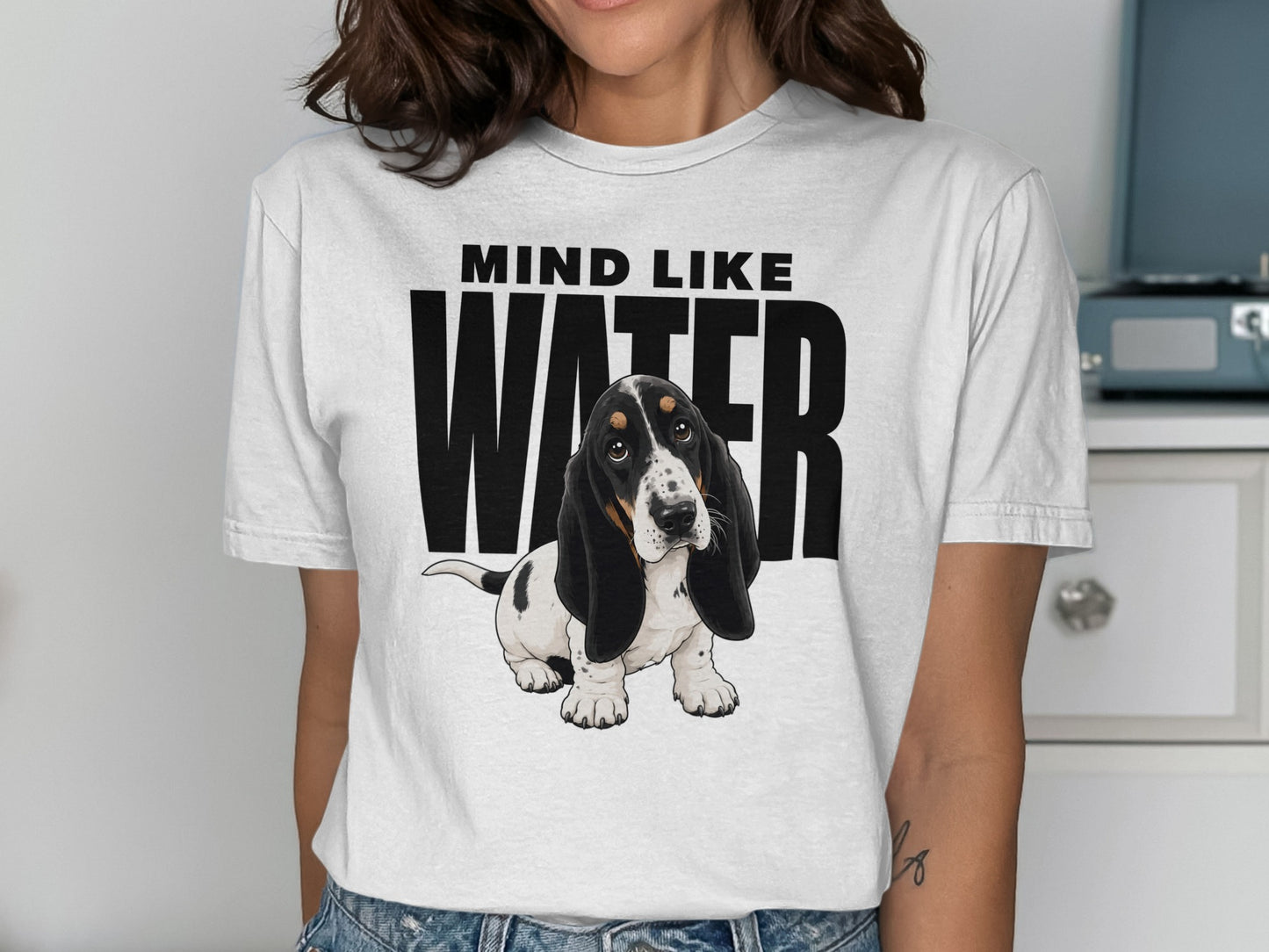 Basset hound puppy on a t-shirt with "MIND LIKE WATER" text.