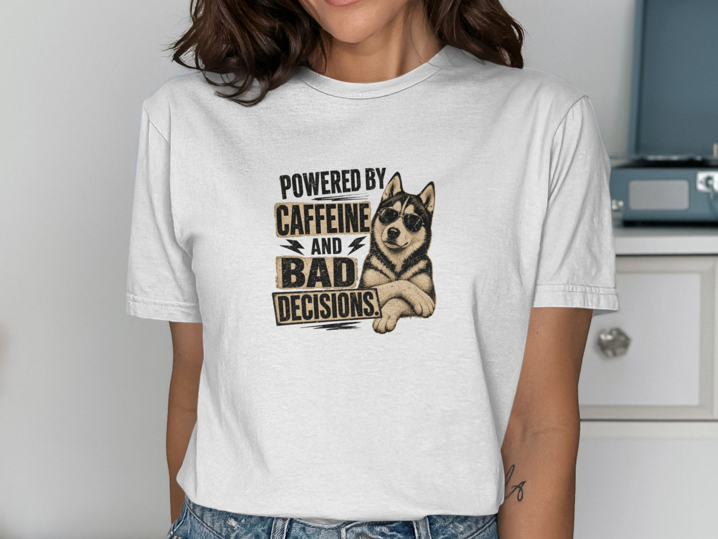 White t-shirt with husky wearing sunglasses and text "POWERED BY CAFFEINE AND BAD DECISIONS".