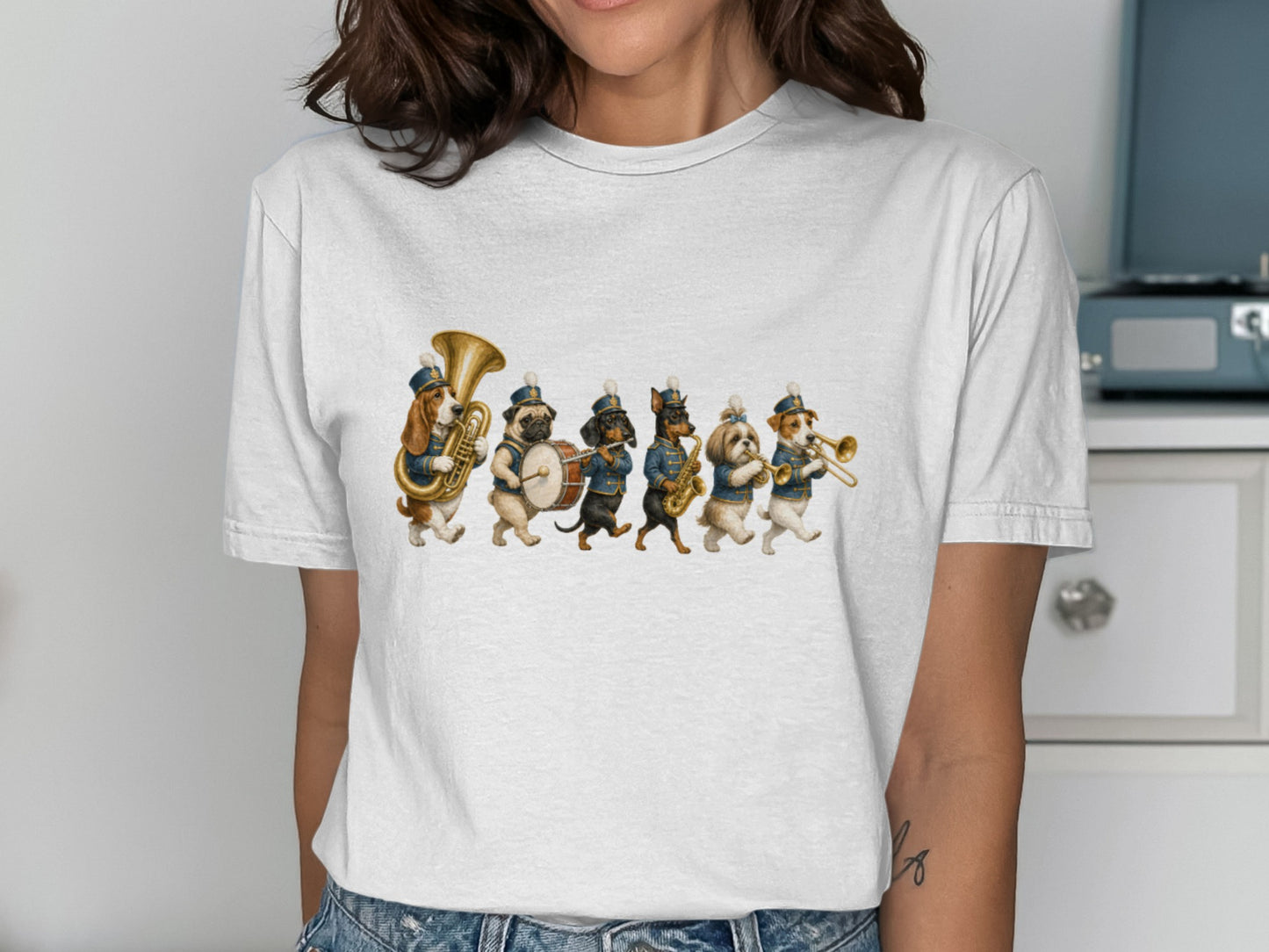 Dogs in marching band uniforms play instruments on a white t-shirt.