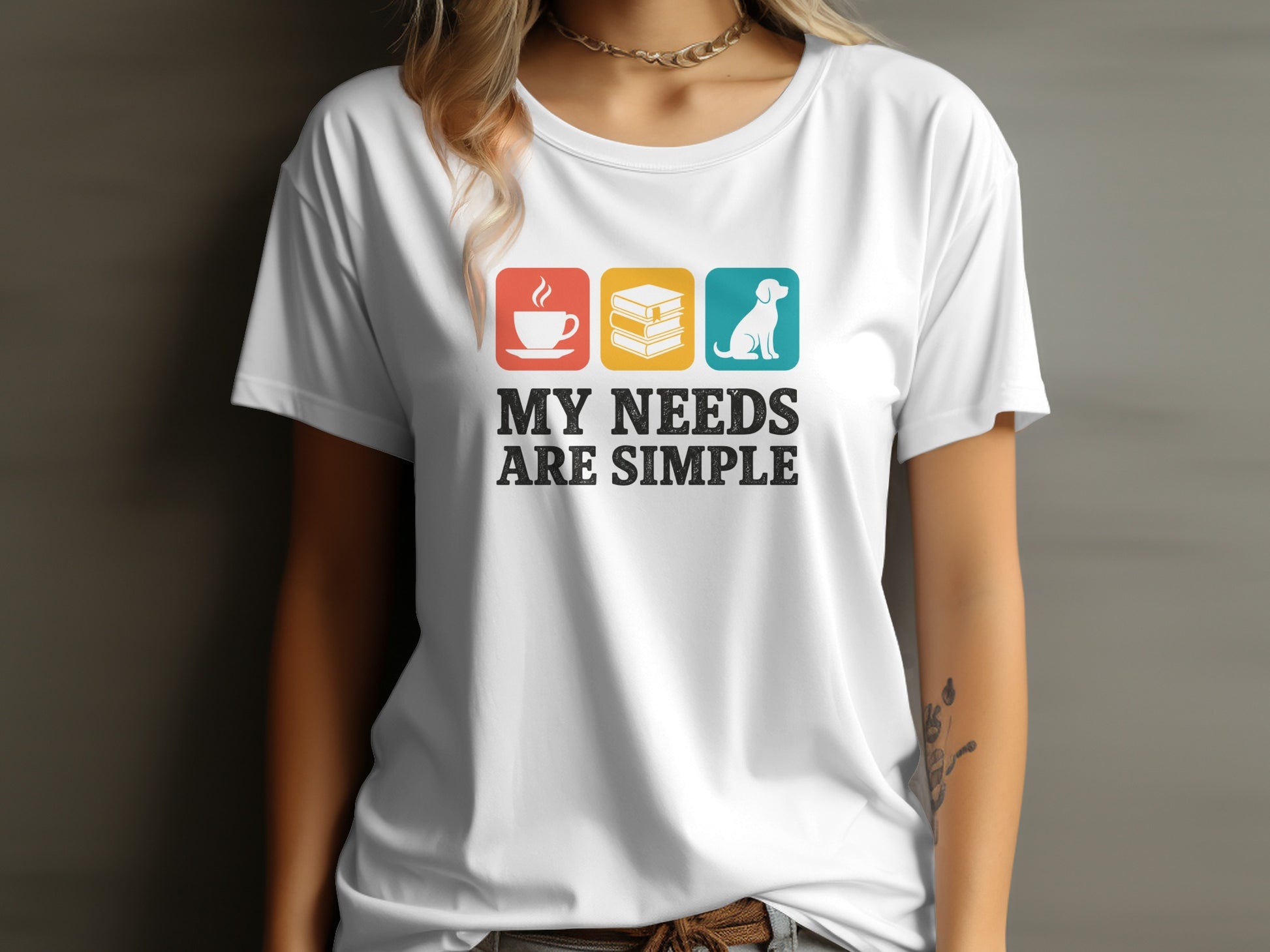 White t-shirt graphic with coffee, books, and dog icons, and text "MY NEEDS ARE SIMPLE".