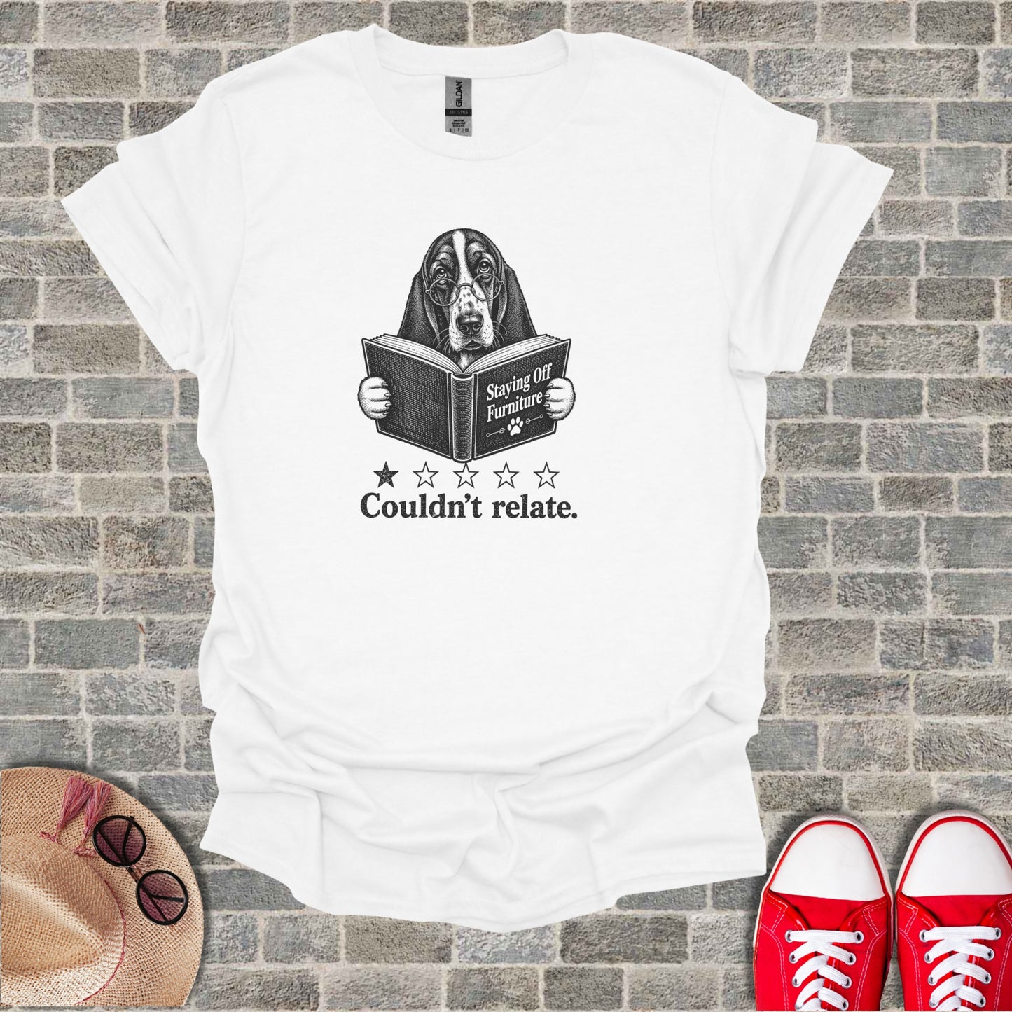White t-shirt with a dog reading a book titled "Staying Off Furniture" with "Couldn't relate."