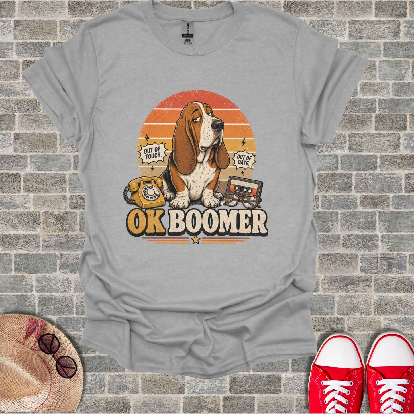 Basset hound wearing sunglasses with "OK Boomer" text, vintage phone, and cassette tape.