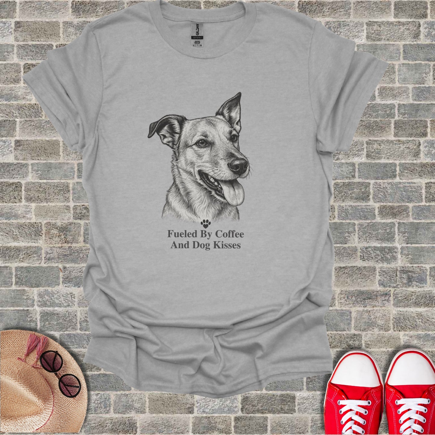 Grey t-shirt with a dog sketch and text: Fueled By Coffee And Dog Kisses.