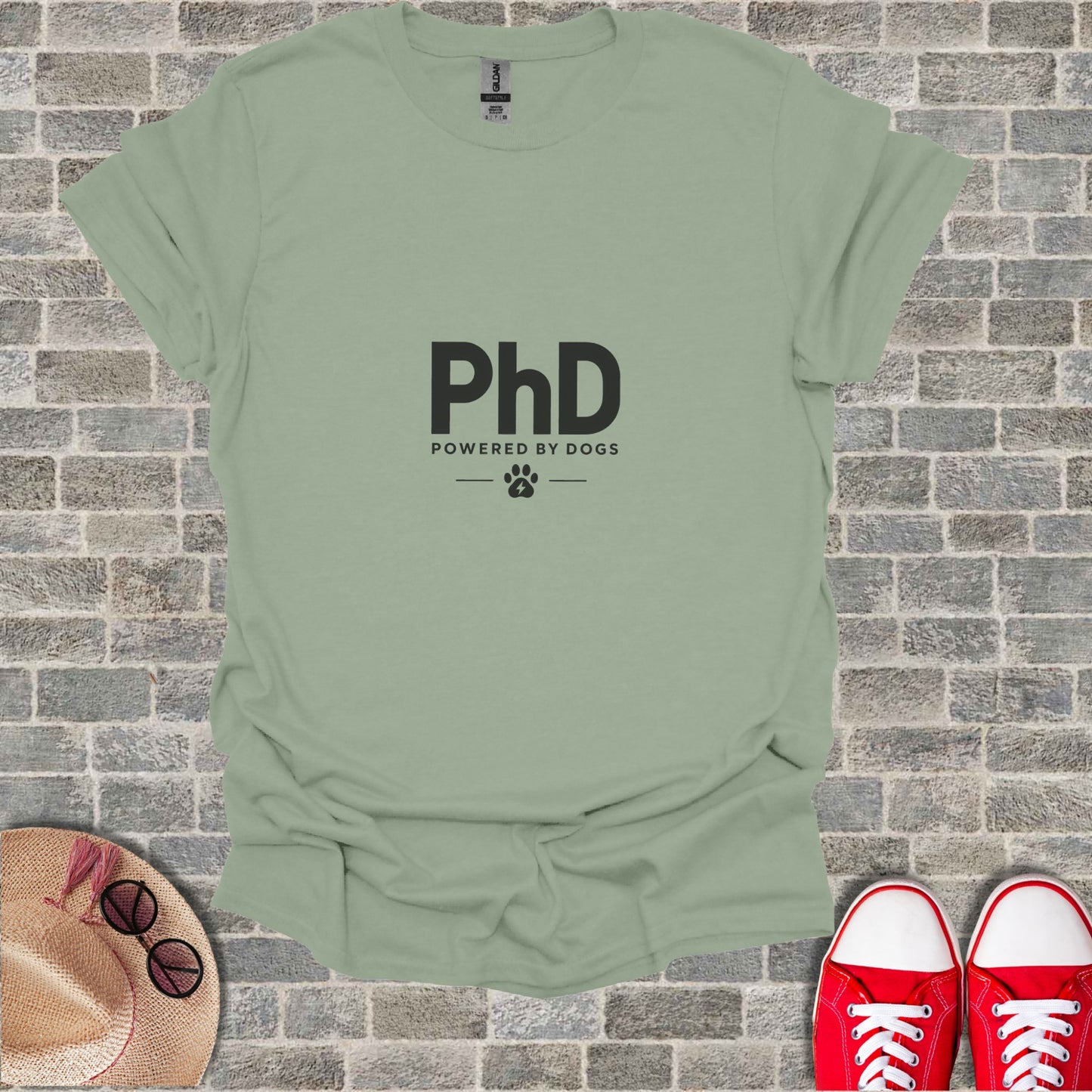 Green t-shirt with "PhD Powered by Dogs" text and paw print graphic.