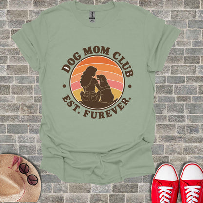 Distressed "Dog Mom Club Est. Furever" graphic on light green t-shirt.