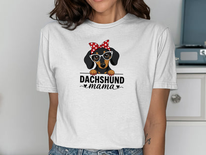 Dachshund mama text on a white t-shirt with a cartoon dachshund wearing glasses and a bandana.