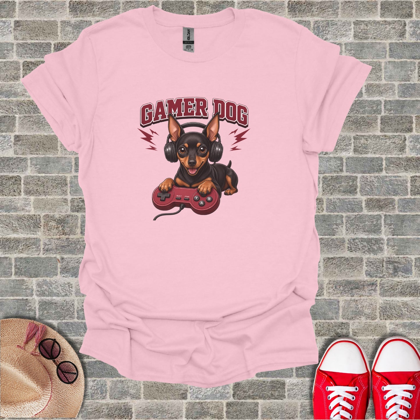 Pink t-shirt with gamer dog holding a controller and wearing headphones.