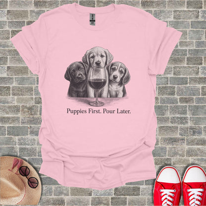 Pink t-shirt with sketch of three puppies and wine glass, "Puppies First. Pour Later."