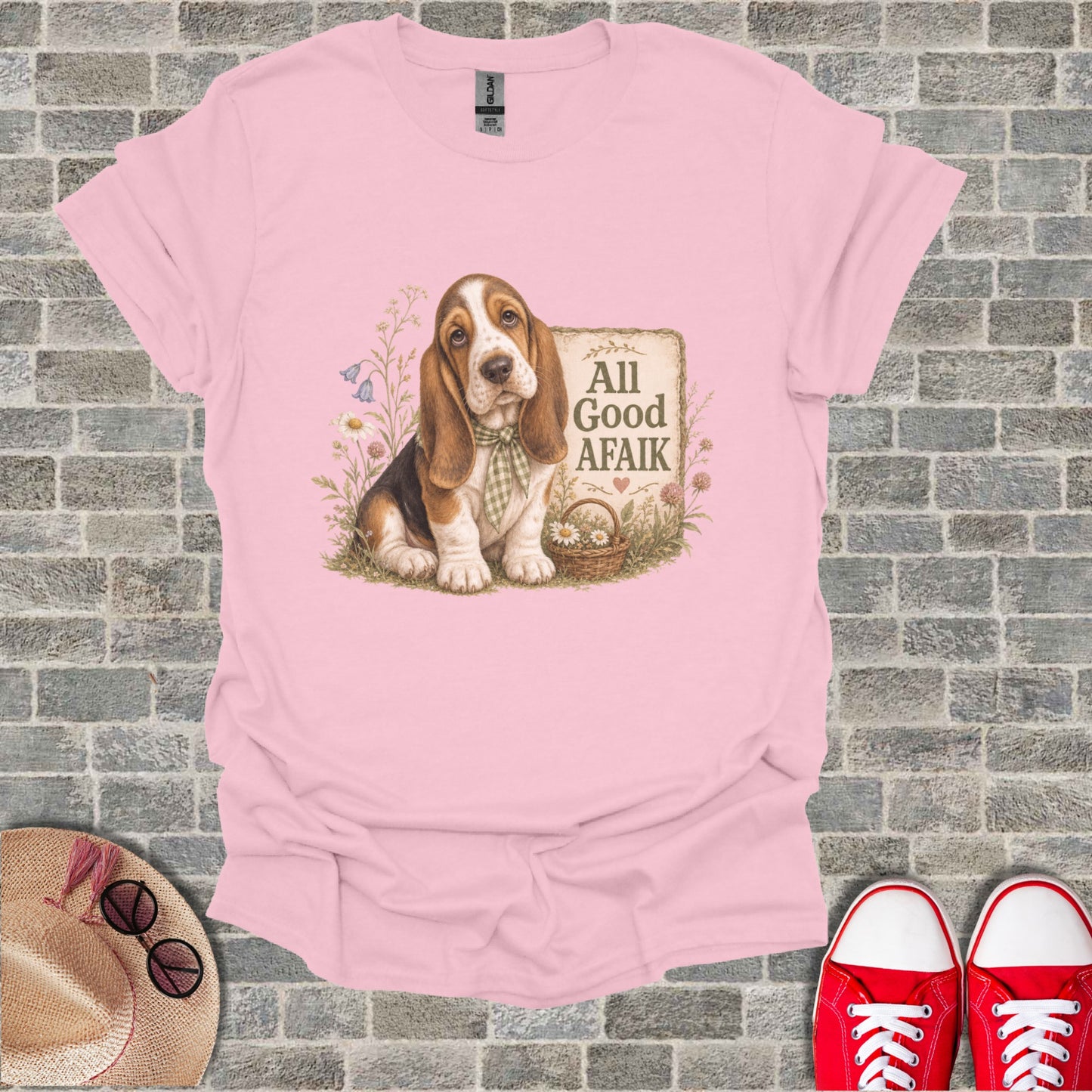 Basset Hound wearing a bandana sits next to a basket with "All Good Afaik" text.