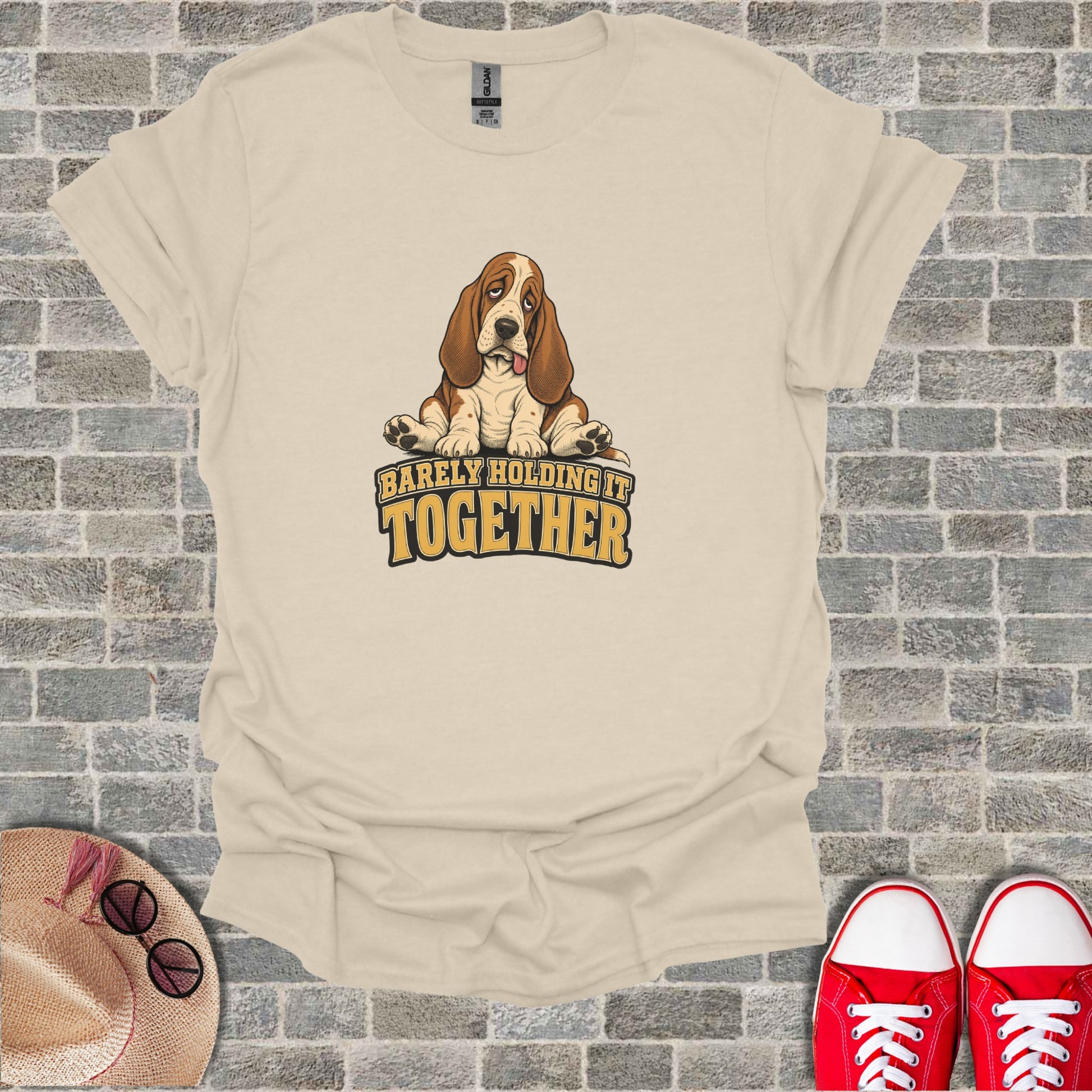 T-shirt with a sad Basset Hound and text that reads "Barely Holding It Together."