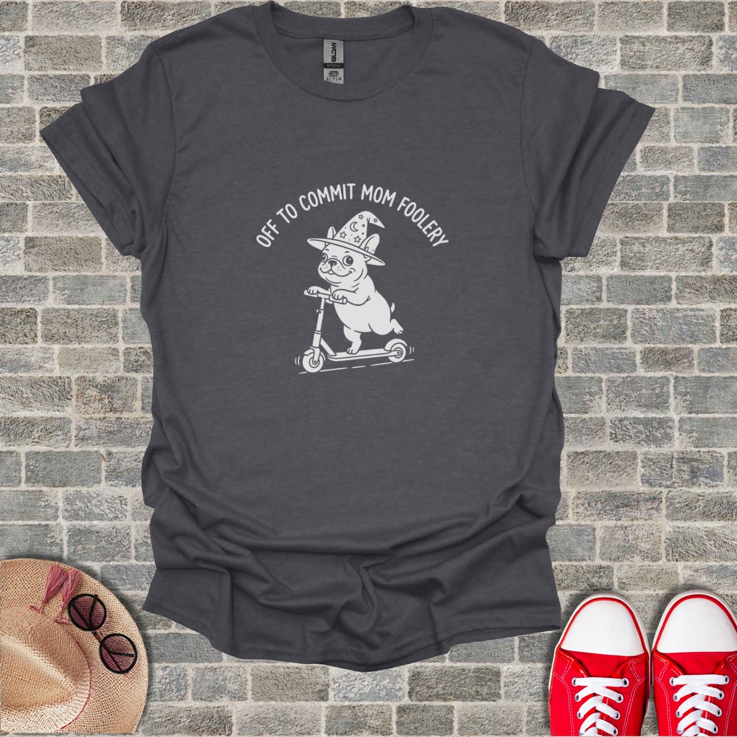 Dark gray t-shirt with a white graphic of a dog in a wizard hat riding a scooter.