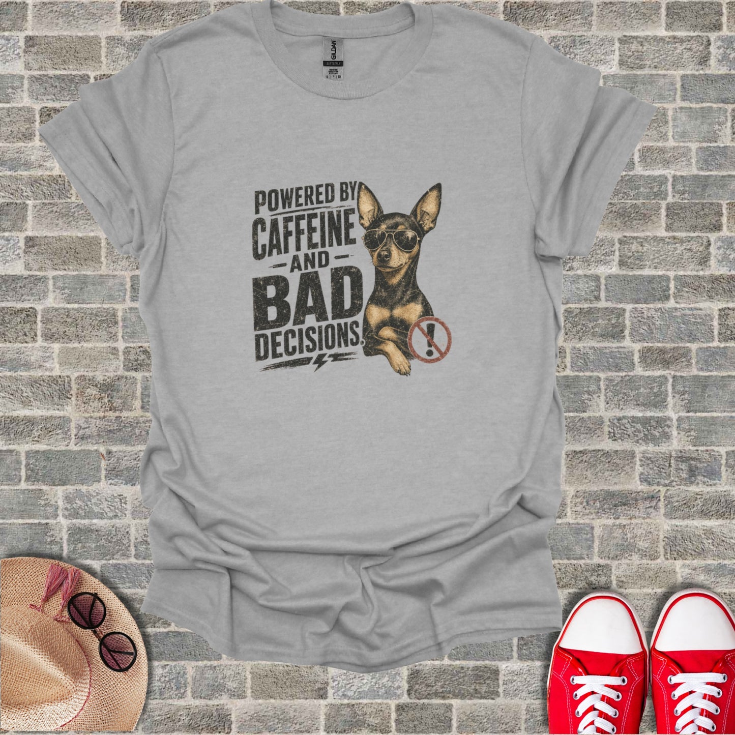 Grey t-shirt with graphic of a chihuahua wearing sunglasses and text "Powered by Caffeine and Bad Decisions".