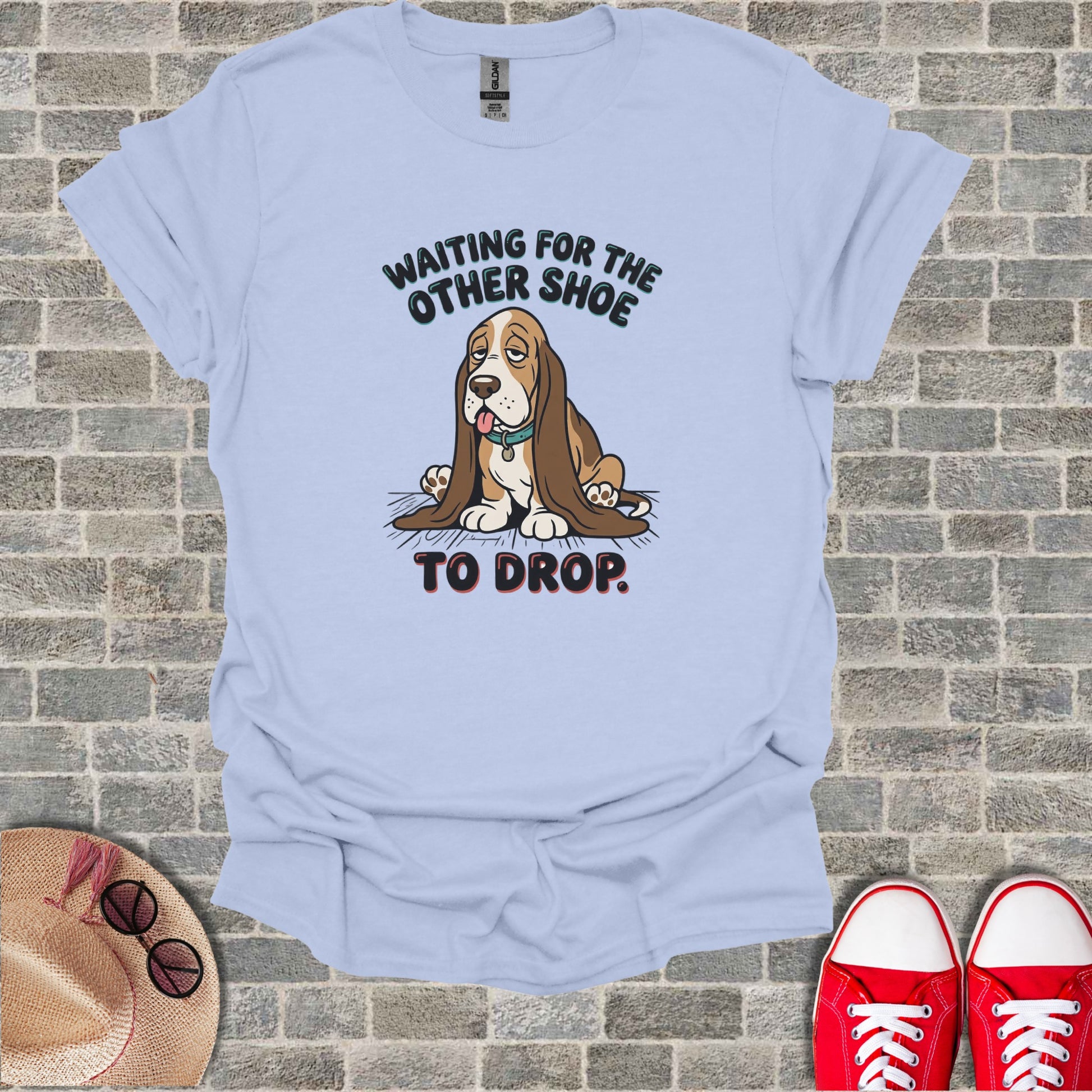 Light blue t-shirt with basset hound graphic and "Waiting for the other shoe to drop." text.