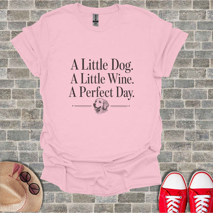 Pink t-shirt with "A Little Dog. A Little Wine. A Perfect Day." and dog graphic.