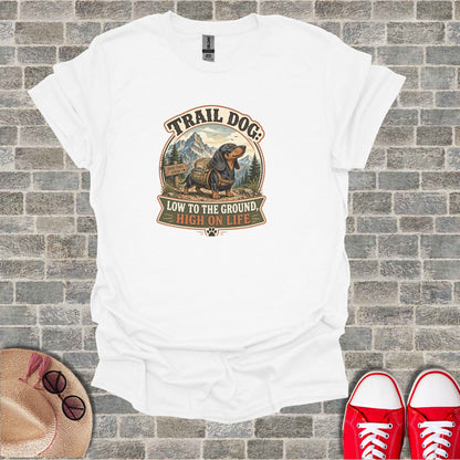 White t-shirt with "Trail Dog: Low to the ground, high on life" and dachshund graphic.