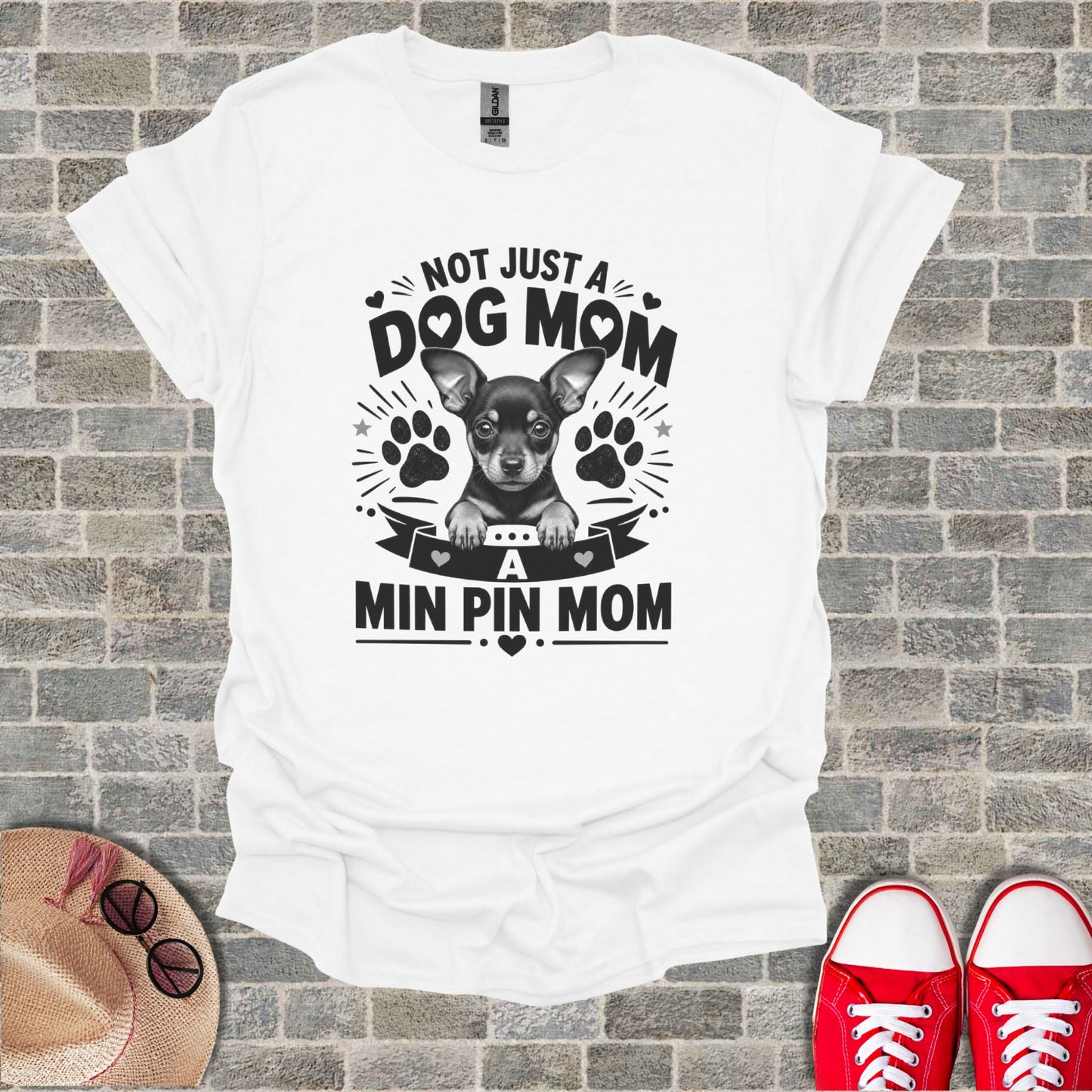 White t-shirt with "Not Just a Dog Mom, A Min Pin Mom" text and a chihuahua graphic.
