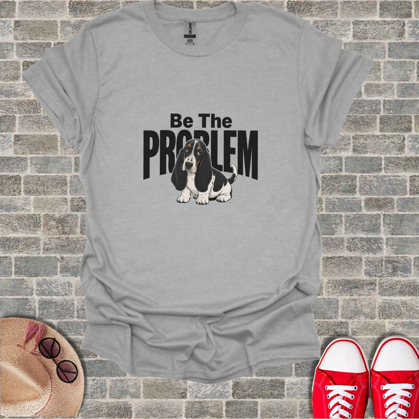 Basset Hound wearing glasses on a gray t-shirt with "Be The PROBLEM" text.