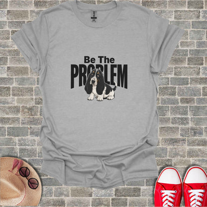 Basset Hound wearing glasses on a gray t-shirt with "Be The PROBLEM" text.