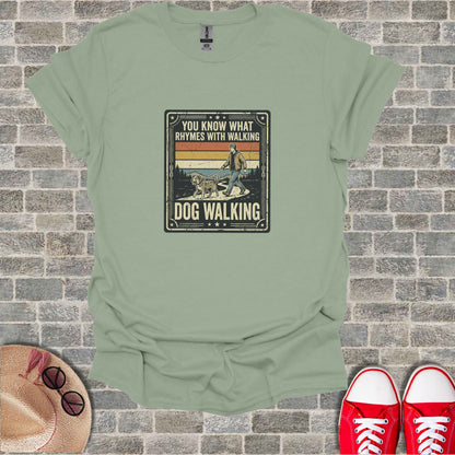 T-shirt with "Dog Walking" text and graphic, on a brick wall.