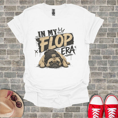 White t-shirt with a pug wearing a beanie and "IN MY FLOP ERA" text.