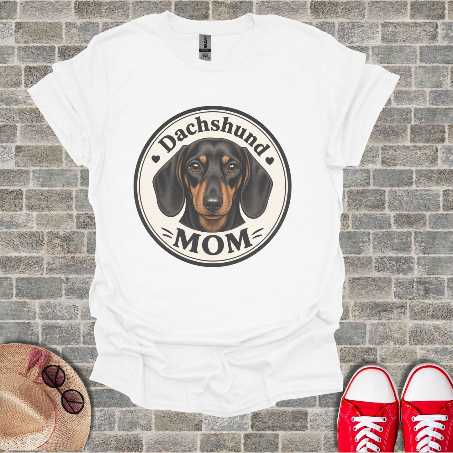 White t-shirt with a Dachshund Mom graphic featuring a dachshund's face.