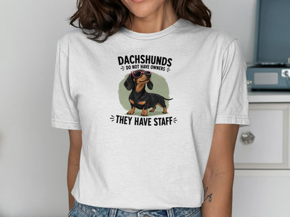 White t-shirt with dachshund graphic and "Dachshunds do not have owners, they have staff" text.