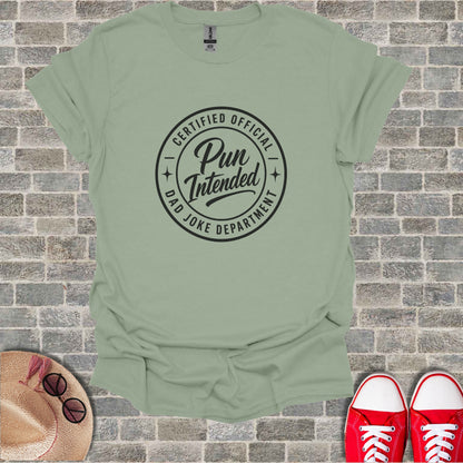 Green t-shirt with "Certified Official Pun Intended Dad Joke Department" circular logo.