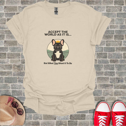 French bulldog wearing sunglasses sits in front of a sunset, text reads "ACCEPT THE WORLD AS IT IS... Not What You Want It To Be".