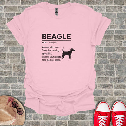 Pink t-shirt with black text "BEAGLE noun. (bee-guhl) A nose with legs, Selective hearing specialist. Will sell your secrets for a piece of bacon."