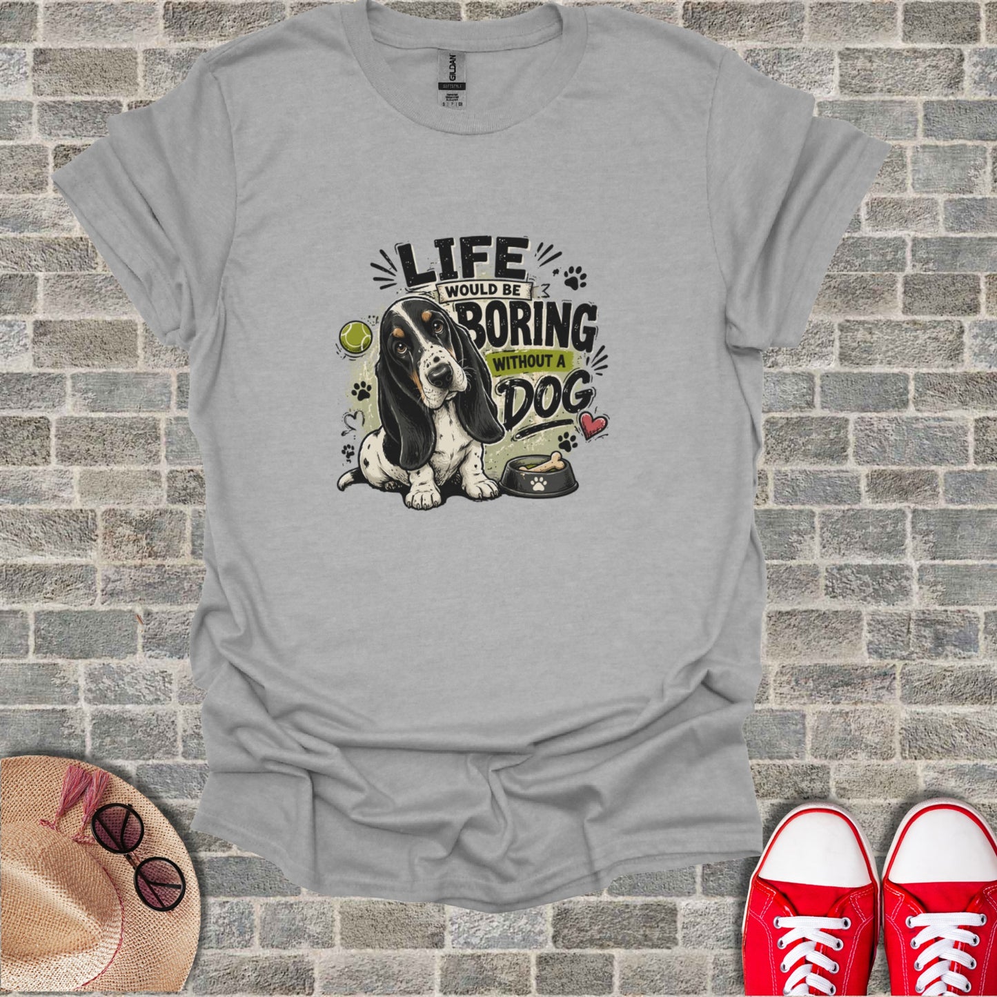 T-shirt graphic with Basset Hound, bone, tennis ball, and text "LIFE WOULD BE BORING WITHOUT A DOG".
