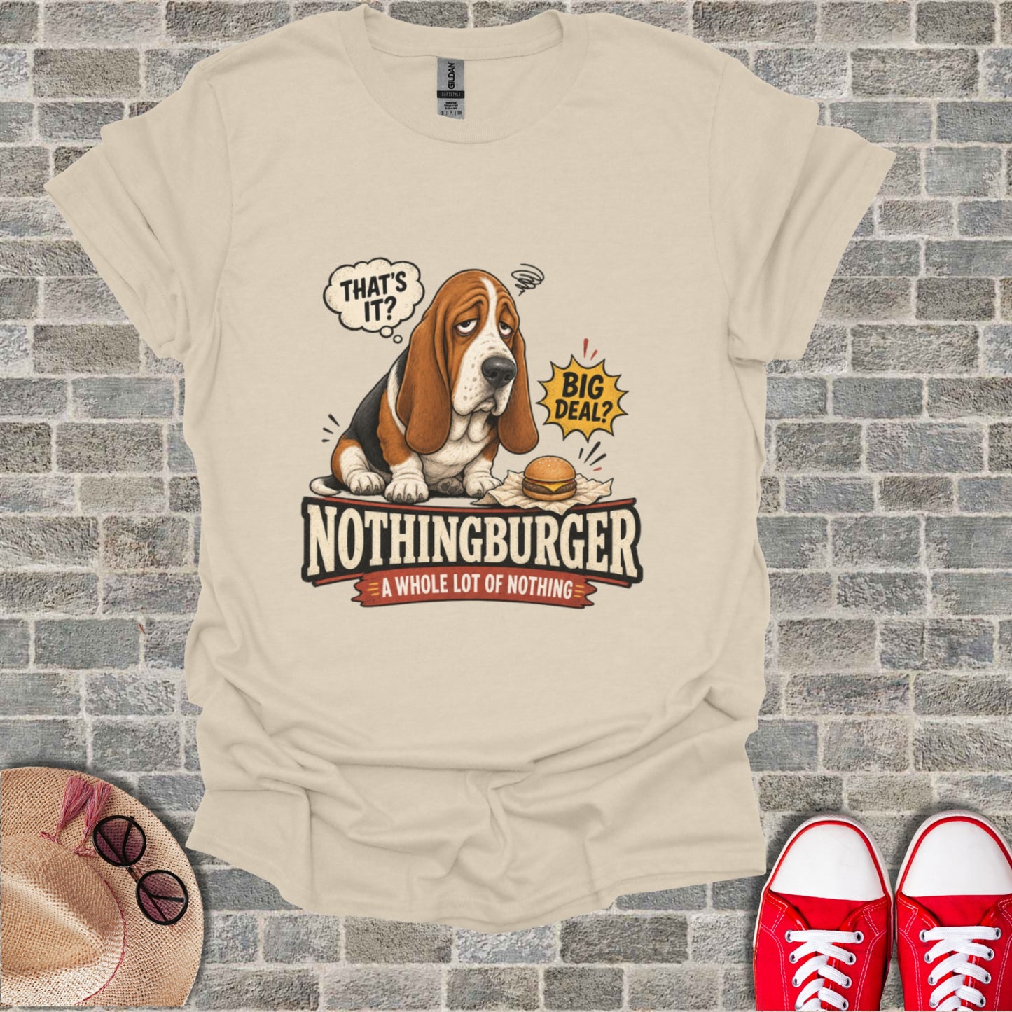Basset hound wearing a t-shirt that says "NOTHINGBURGER: A WHOLE LOT OF NOTHING".