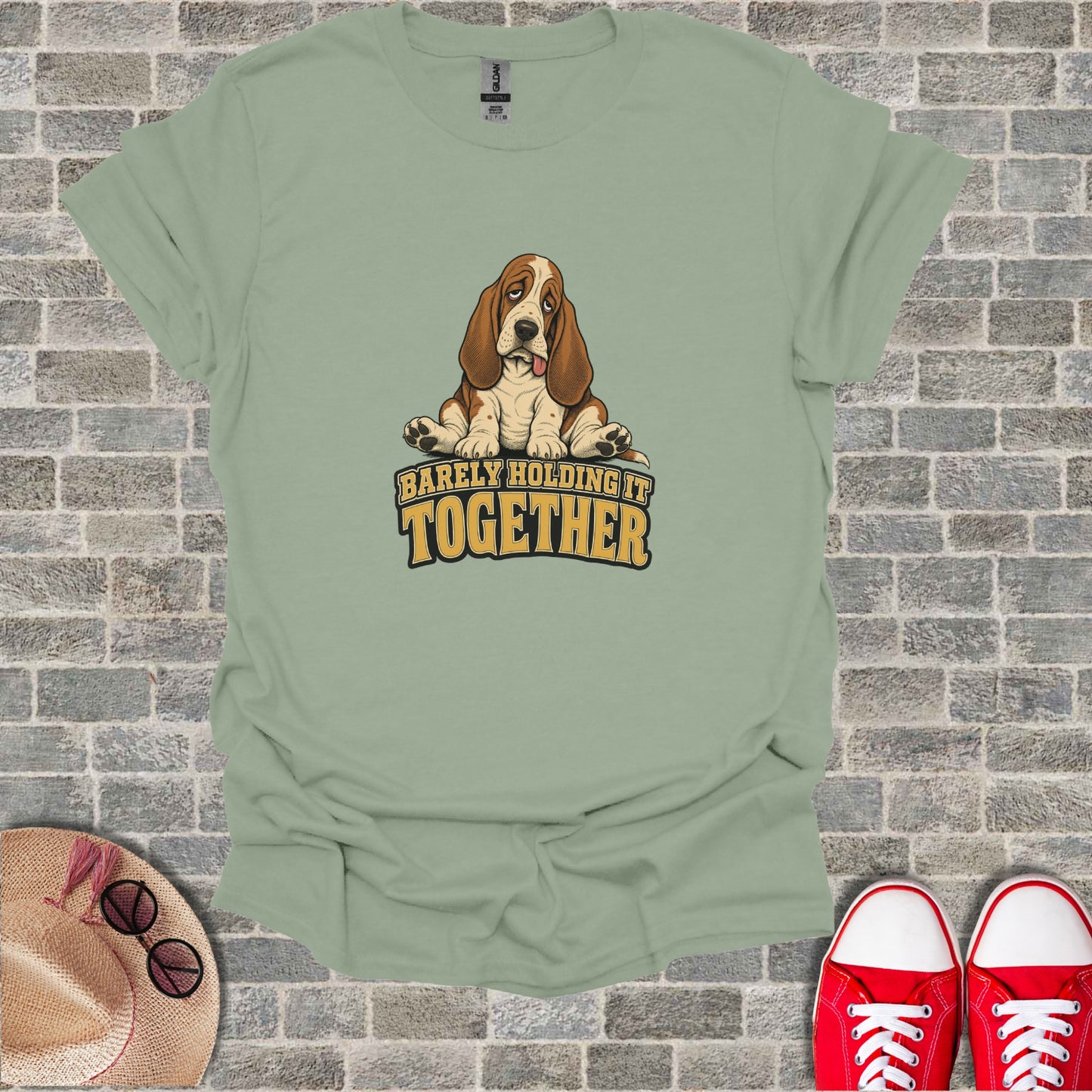 Green t-shirt with a cartoon Basset Hound saying "Barely Holding It Together".