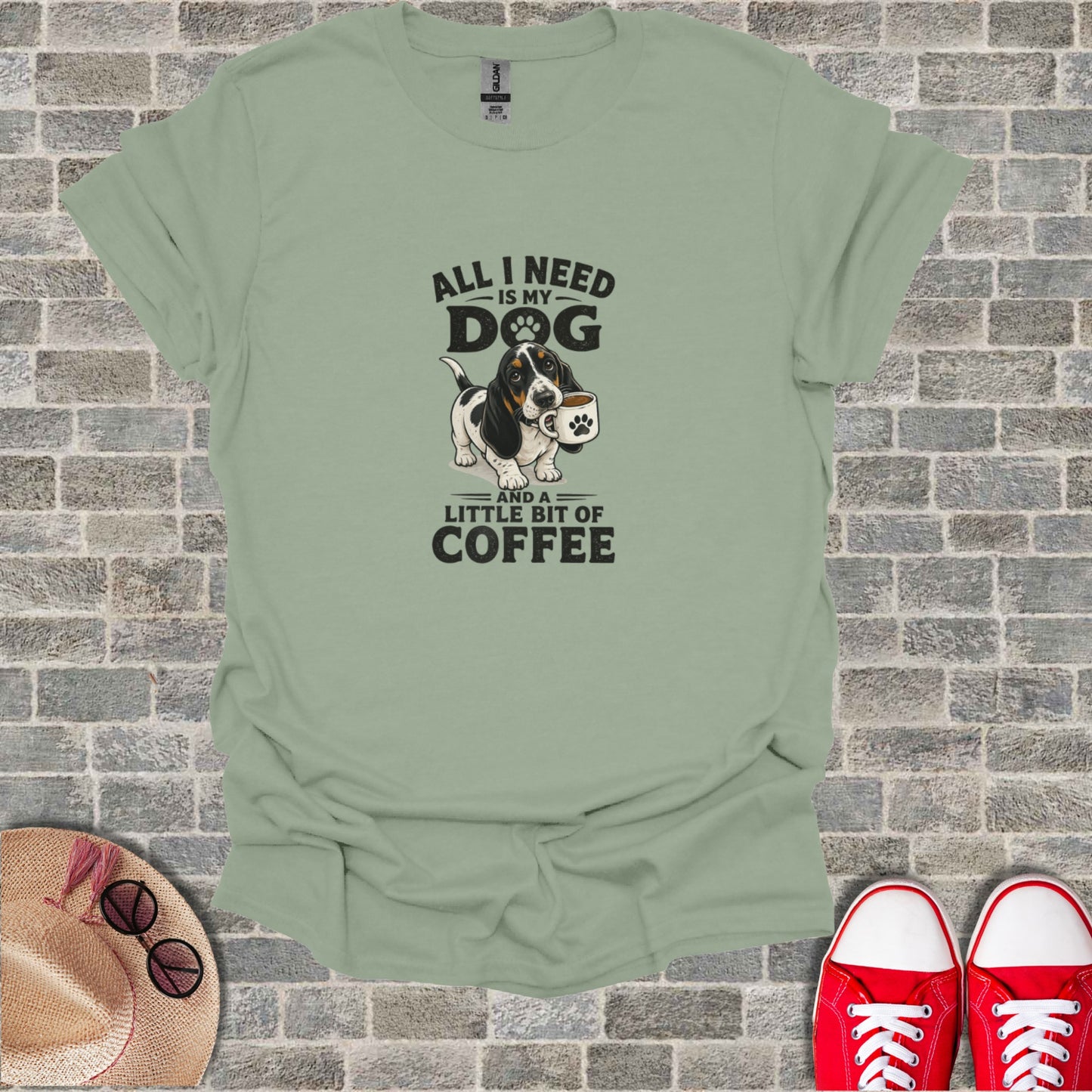 T-shirt with cartoon dog holding a coffee mug and text "All I need is my dog and a little bit of coffee".