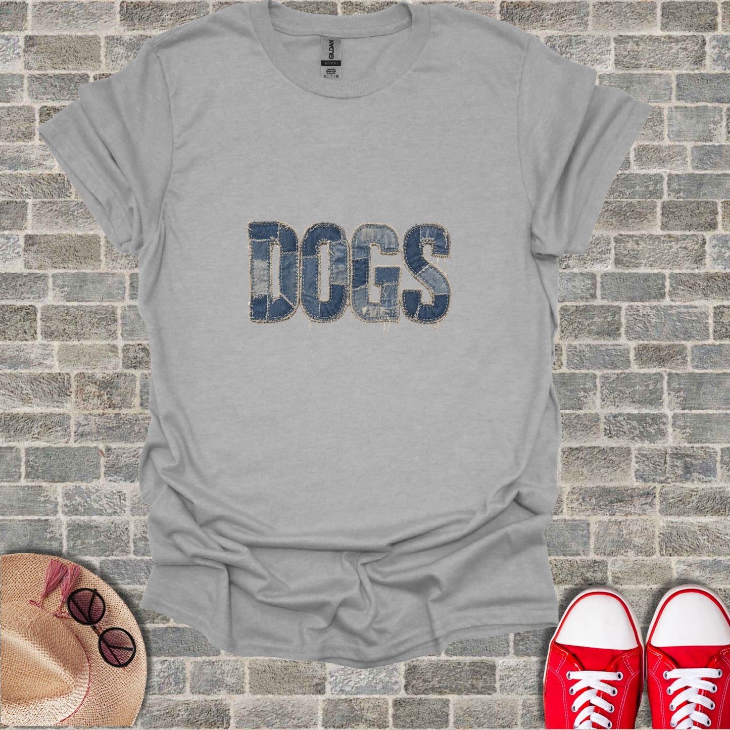 Grey t-shirt with "DOGS" in denim patch lettering.
