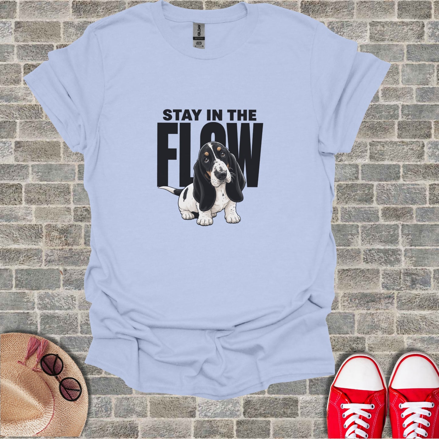 Light blue t-shirt with a cartoon basset hound and text "STAY IN THE FLOW".