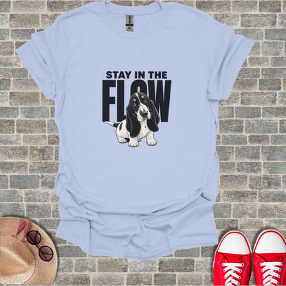 Light blue t-shirt with a cartoon basset hound and text "STAY IN THE FLOW".