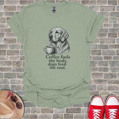 Light green t-shirt with a sketch of a golden retriever and coffee, text reads "Coffee fuels the body, dogs feed the soul."
