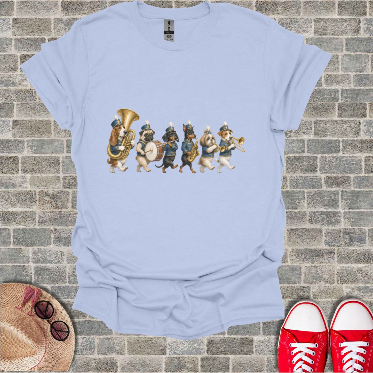 Light blue t-shirt with embroidered dogs playing in a marching band.