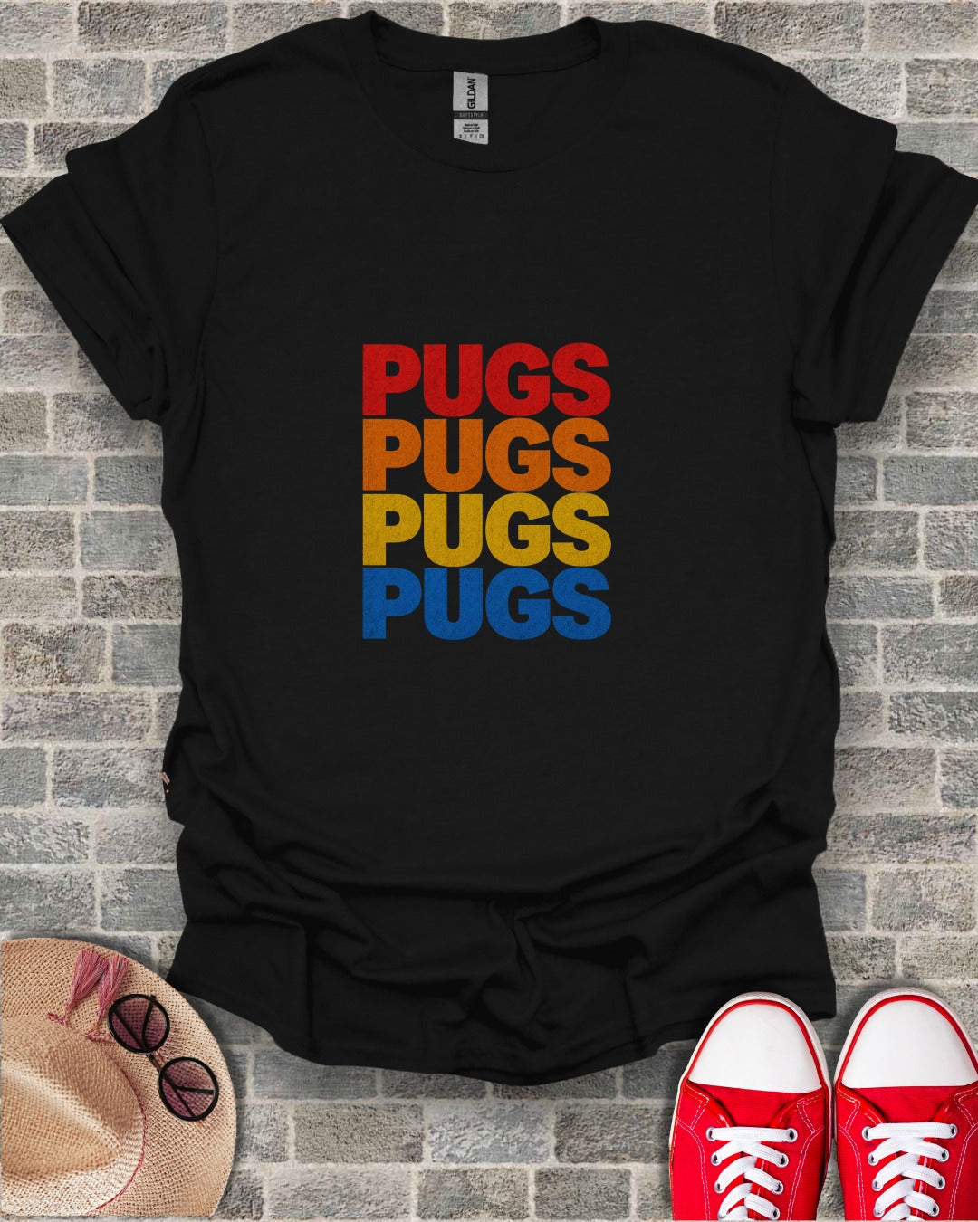 Black t-shirt with "PUGS" repeated in colorful stripes: red, orange, yellow, blue.