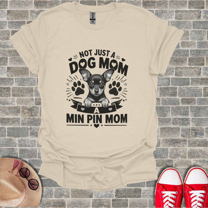 Cream t-shirt with black graphic "Not Just a Dog Mom, A Min Pin Mom" and chihuahua.