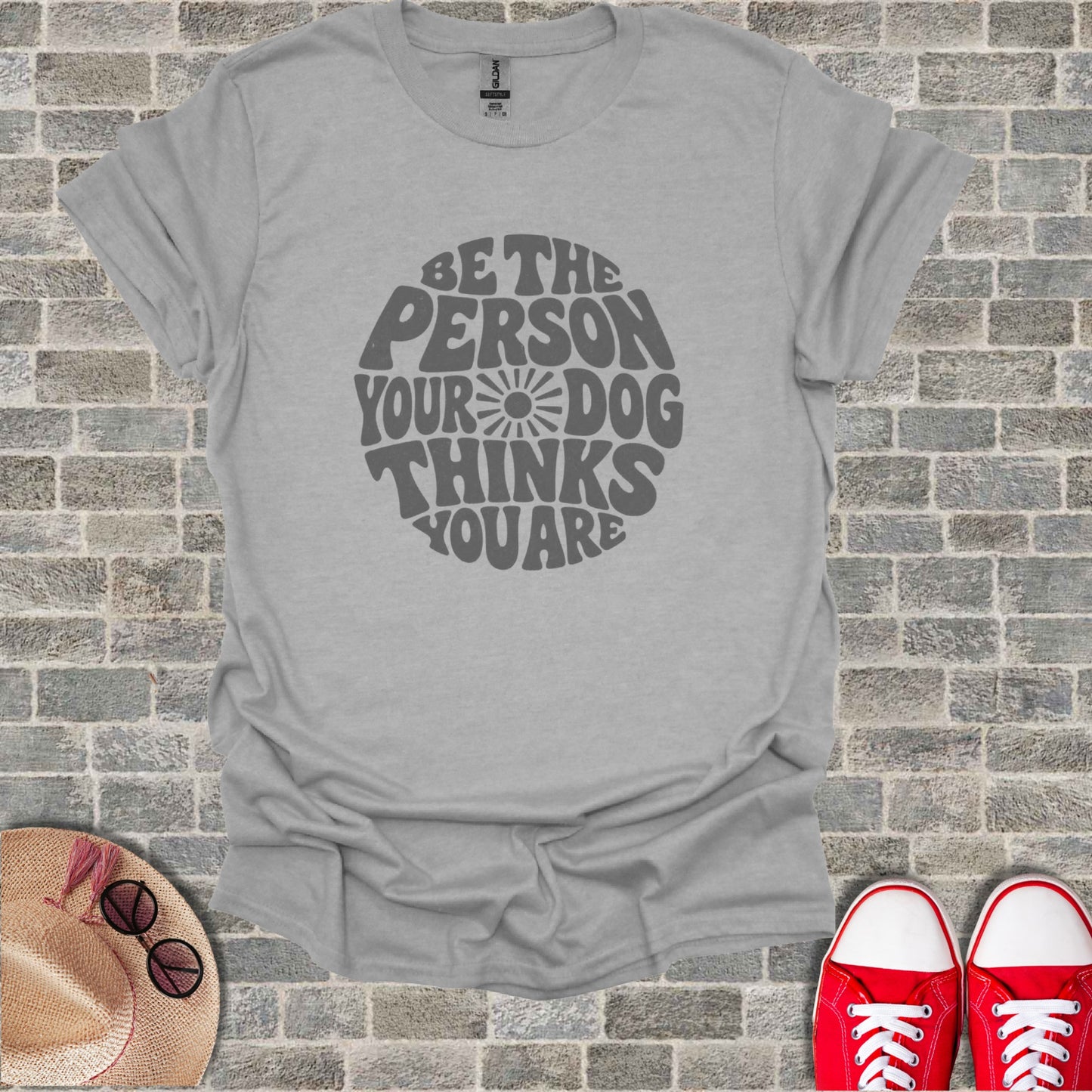 Light grey t-shirt with "Be the person your dog thinks you are" text graphic.