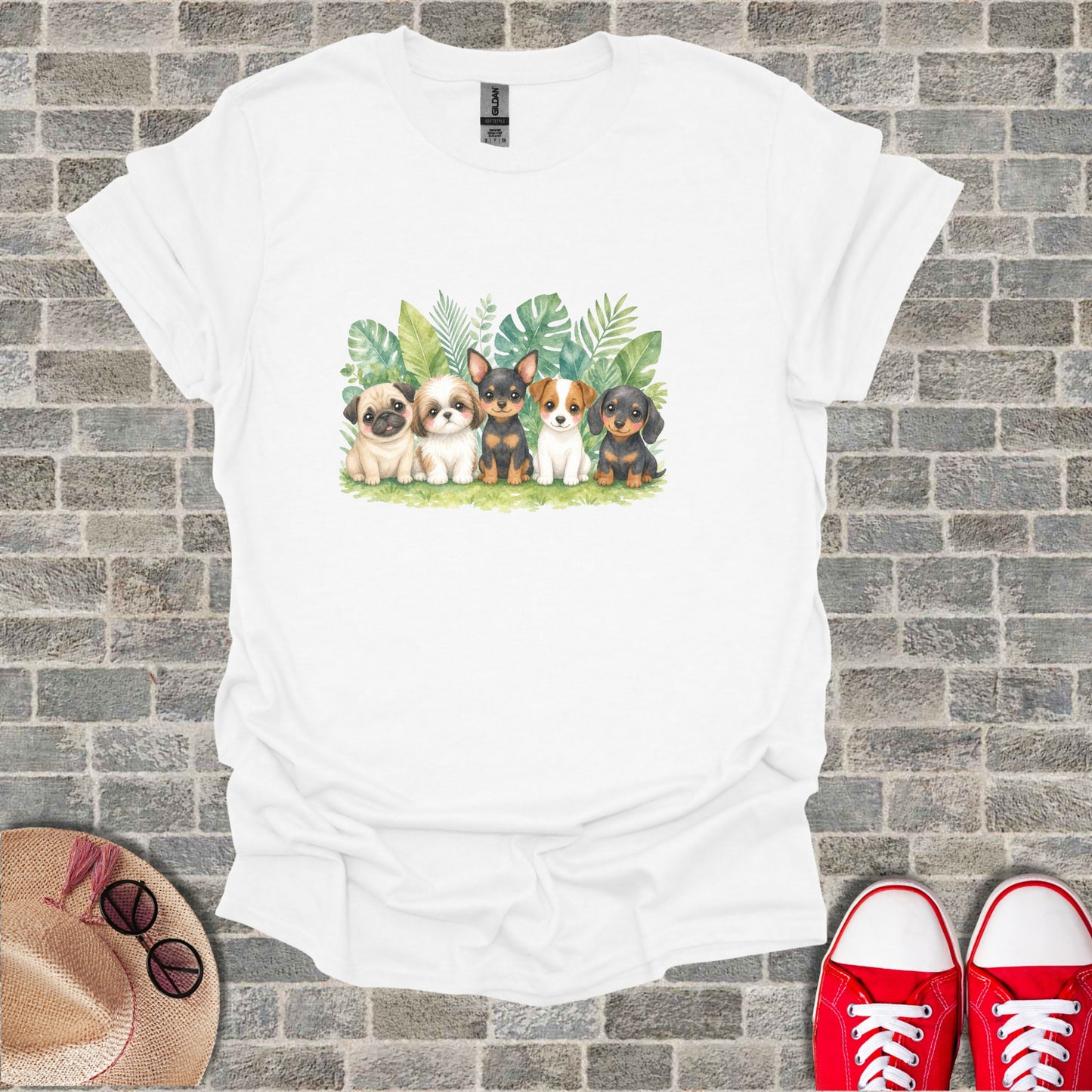Five watercolor puppies sit in a row with green leaves behind them.